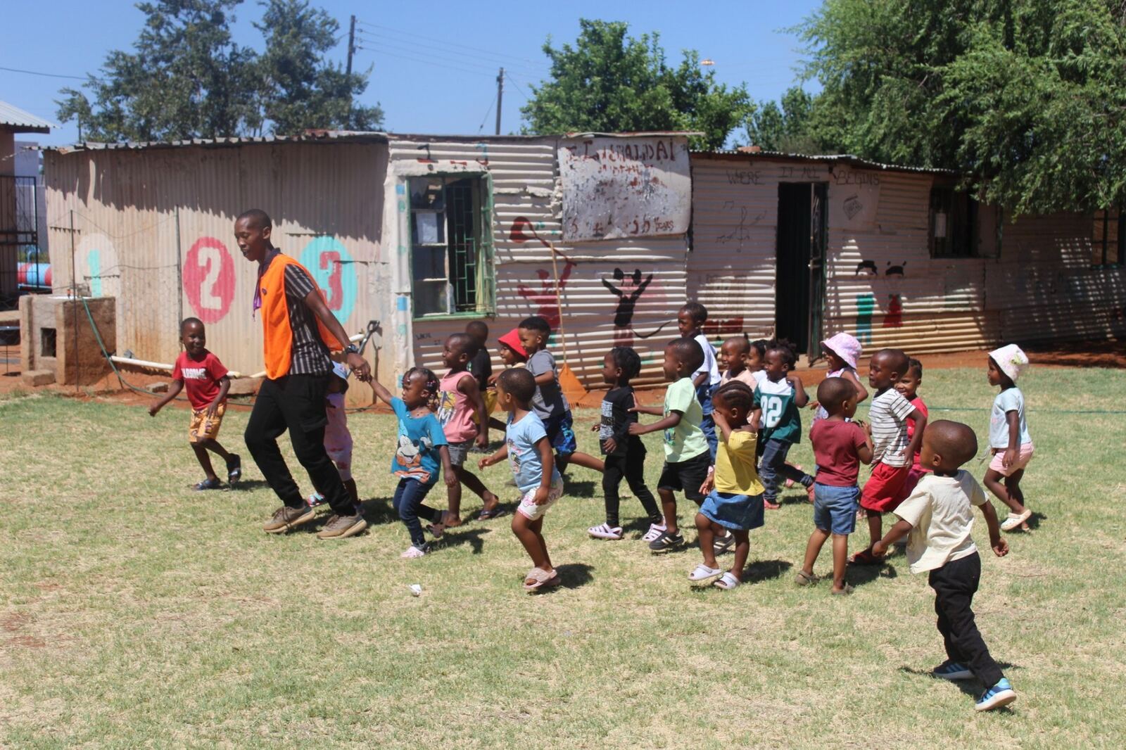 A coach leading a group of children at a workshop
